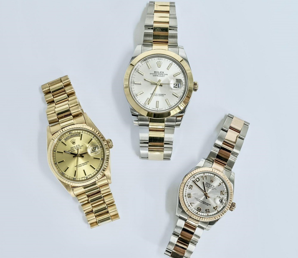 Three Rolex wristwatches with metal bands—one gold, one silver and gold, and one silver and rose gold—are arranged on a white background. Sell a Rolex with aftermarket parts in Atlanta or view these stunning examples.