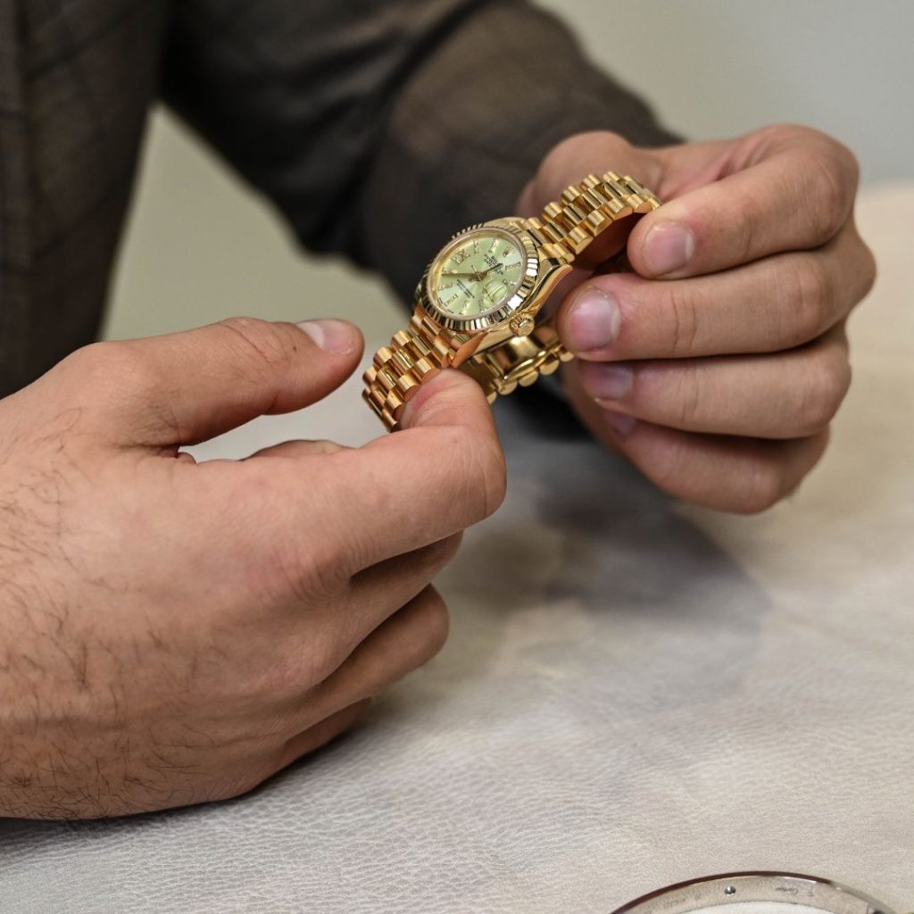 DB employee holding a Rolex watch